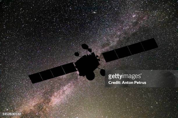 communications satellite on the background of the starry sky. satellite connection - satellite image stock pictures, royalty-free photos & images