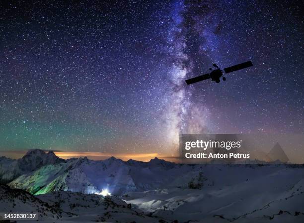 communications satellite on the background of the starry sky at mountains. satellite connection - audio receiver stock pictures, royalty-free photos & images