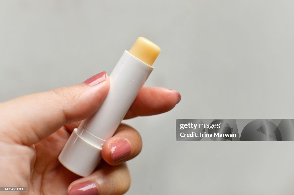 Woman holding a lip balm