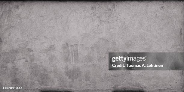 front view of a plastered gray stone wall with stains from graffiti removal. - cleaning graffiti stock pictures, royalty-free photos & images