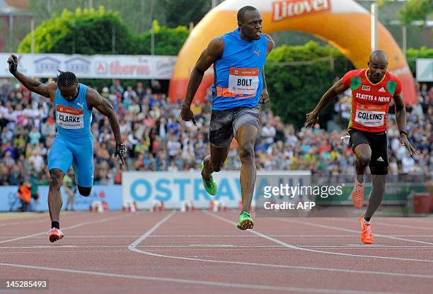 Jamaica sprinter Usain Bolt crosses the finish line ahead of Lerone Clarke of Jamaica and Kim Collins of Saint Kitts and Nevis, during the men's 100m...