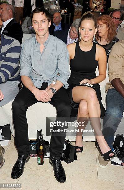 Actors Nicholas Hoult and Jennifer Lawrence attend a cocktail reception during Amber Lounge Fashion Monaco 2012 at Le Meridien Beach Plaza Hotel on...