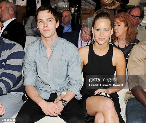 Actors Nicholas Hoult and Jennifer Lawrence attend a cocktail reception during Amber Lounge Fashion Monaco 2012 at Le Meridien Beach Plaza Hotel on...