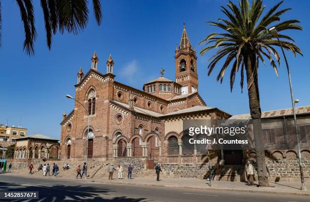 Pedestrians walk in front of the Cathedral Our Lady of the Rosary Catholic Church on Harnet Avenue in the city center on December 27, 2022 in Asmara,...