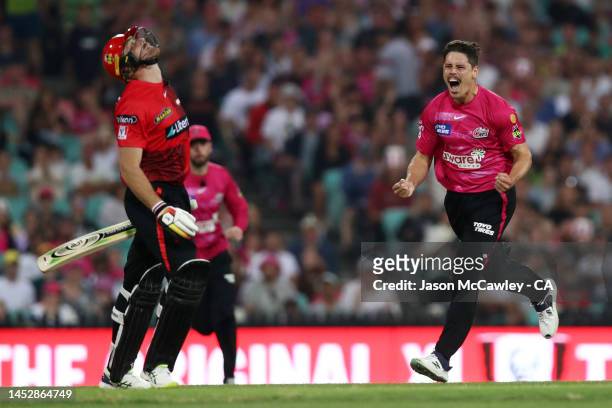 Ben Dwarshuis of the Sixers celebrates after taking the wicket of Martin Guptill of the Renegades during the Men's Big Bash League match between the...