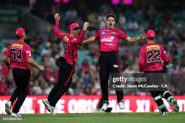 Ben Dwarshuis of the Sixers celebrates after taking the wicket of Martin Guptill of the Renegades during the Men's Big Bash League match between the...