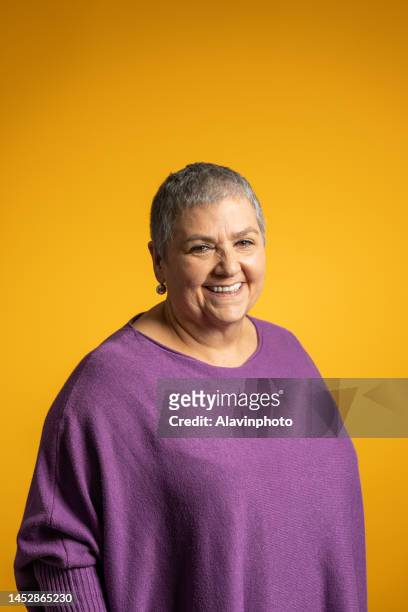 portrait woman with yellow background - old woman short hair stock pictures, royalty-free photos & images
