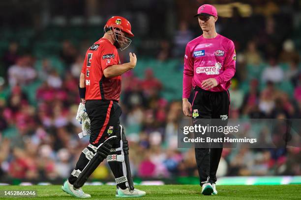 Aaron Finch of the Renegades reacts after being struck in the hand by the ball during the Men's Big Bash League match between the Sydney Sixers and...