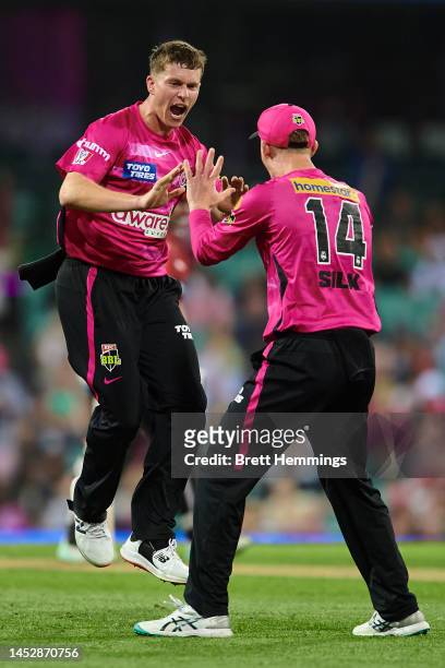 Hayden Kerr of the Sixers celebrates after taking the wicket of Shaun Marsh of the Renegades during the Men's Big Bash League match between the...
