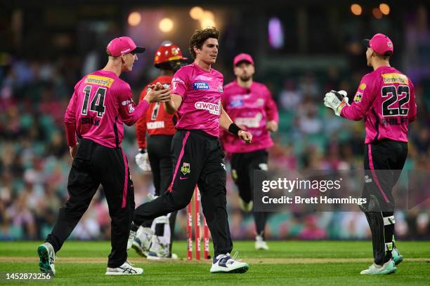 Sean Abbott of the Sixers celebrates after taking the wicket of Akeal Hosein of the Renegades during the Men's Big Bash League match between the...