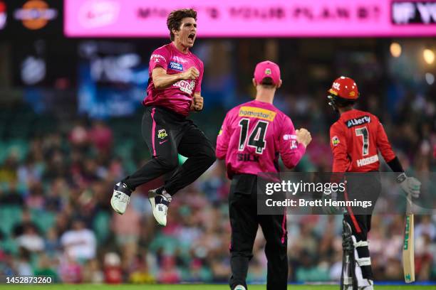Sean Abbott of the Sixers celebrates after taking the wicket of Akeal Hosein of the Renegades during the Men's Big Bash League match between the...