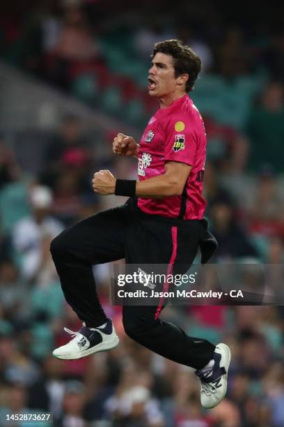 Sean Abbott of the Sixers celebrates after taking the wicket of Akeal Hosein of the Renegades during the Men's Big Bash League match between the...