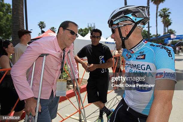 Race Director Jim Birrell of Medalist Sports talks with Levi Leipheimer of USA riding for Omega Pharma-QuickStep prior to the start of stage seven of...