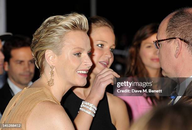 Princess Charlene of Monaco, actress Jennifer Lawrence and Prince Albert II of Monaco attend the Amber Lounge Fashion Show Monaco 2012 at Le Meridien...