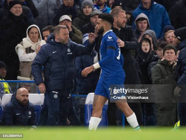 Reece James of Chelsea FC walks past Head Coach Graham Potter and Assistant Coach Billy Reid after picking up another injury during the Premier...