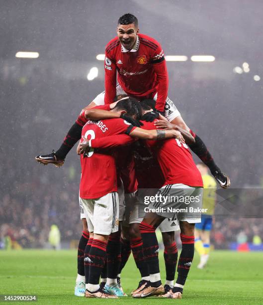 Anthony Martial of Manchester United celebrates with Casemiro and team mates after scoring their side's second goal during the Premier League match...