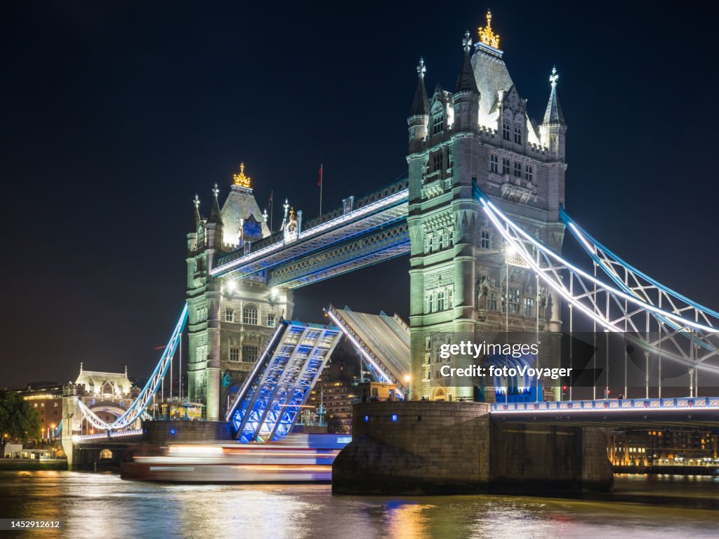 London Tower Bridge illuminated at night over River Thames UK