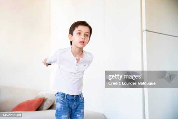 kid playing with gamepad at hom - hom stock pictures, royalty-free photos & images