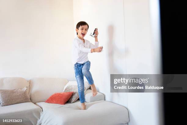 kid playing with gamepad at hom - hom stock pictures, royalty-free photos & images