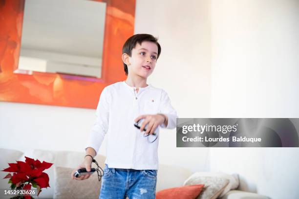 kid playing with gamepad at hom - hom stock pictures, royalty-free photos & images