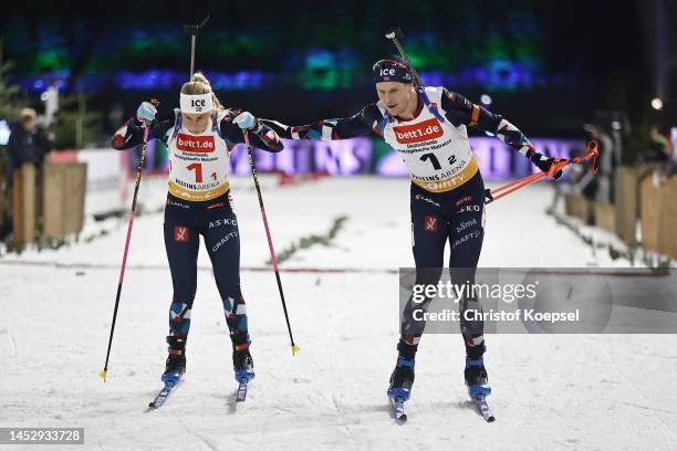 Ingrid Landmark Tandrevold of Norway and Vetle Sjastad Christiansen of Norway during a change of the mass start race of the Bett1 Biathlon Team...