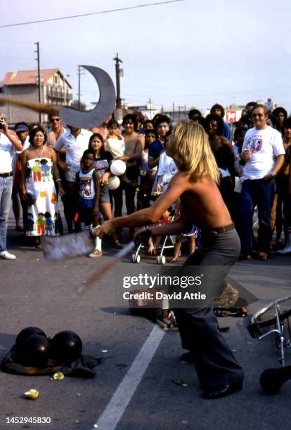 Street performer juggles a cleaver, a machete, and a scythe in Muscle Beach, the birthplace of the fitness and bodybuilding craze, in September, 1979...
