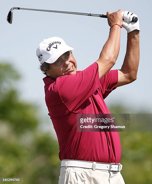 Eduardo Romero of Argentina watches his tee shot on the fourth hole during the second round of the 2012 Senior PGA Championship at the Golf Club at...