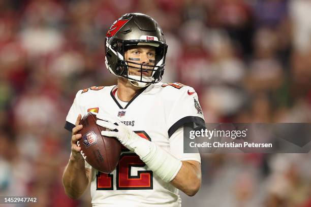 Quarterback Tom Brady of the Tampa Bay Buccaneers drops back to pass during the NFL game at State Farm Stadium on December 25, 2022 in Glendale,...