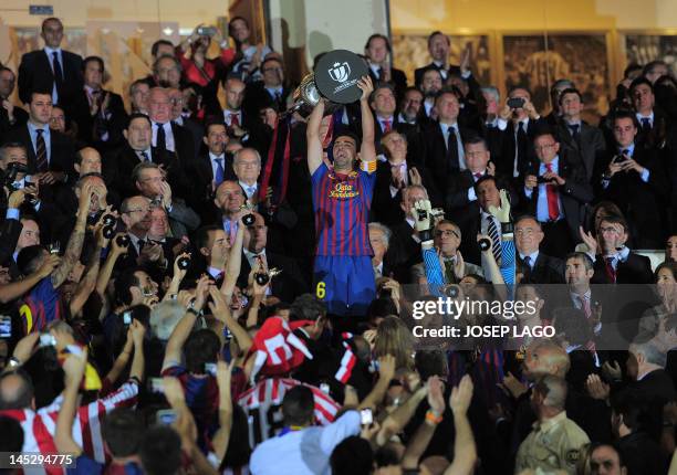 Barcelona's midfielder Xavi Hernandez holds the King's Cup after winning the Spanish King's Cup final match between Athletic Bilbao and FC Barcelona...