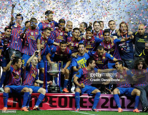 Barcelona players celebrate with the Copa del Rey trophy after beating Athletic Bilbao 3-0 during the Copa del Rey Final at Vicente Calderon Stadium...