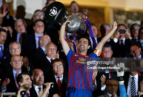 Xavi Hernandez of Barcelona holds the trophy in celebration after a victory in the Copa del Rey Final match between Athletic Bilbao and Barcelona at...