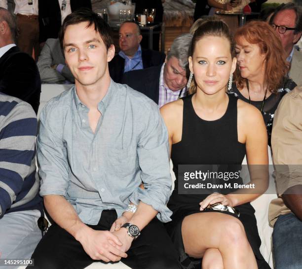 Actors Nicholas Hoult and Jennifer Lawrence attend a cocktail reception during Amber Lounge Fashion Monaco 2012 at Le Meridien Beach Plaza Hotel on...