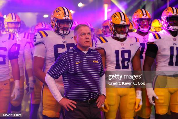 Head coach Brian Kelly of the LSU Tigers stands with his team prior to facing the Georgia Bulldogs in the SEC Championship at Mercedes-Benz Stadium...