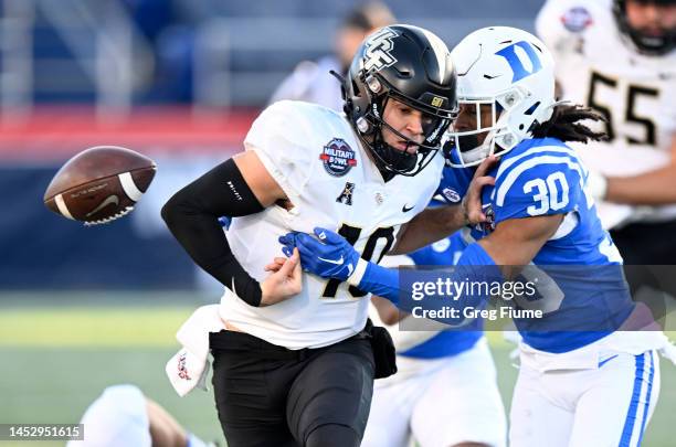 John Rhys Plumlee of the UCF Knights fumbles the ball in the second quarter after being hit by Brandon Johnson of Duke Blue Devils in the Military...