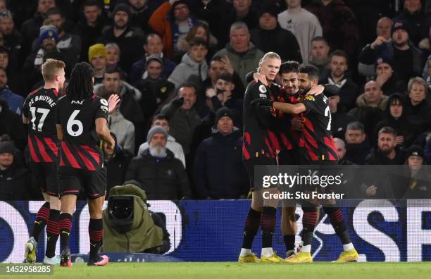 Erling Haaland of Manchester City celebrates with Riyad Mahrez and Jack Grealish after scoring the team's third goal during the Premier League match...