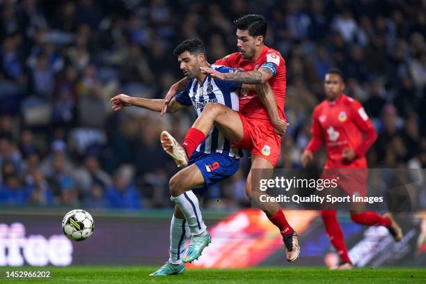 Mehdi Taremi of FC Porto beats Joao Basso of FC Arouca and scores his team third goal during the Liga Portugal Bwin match between FC Porto and FC...