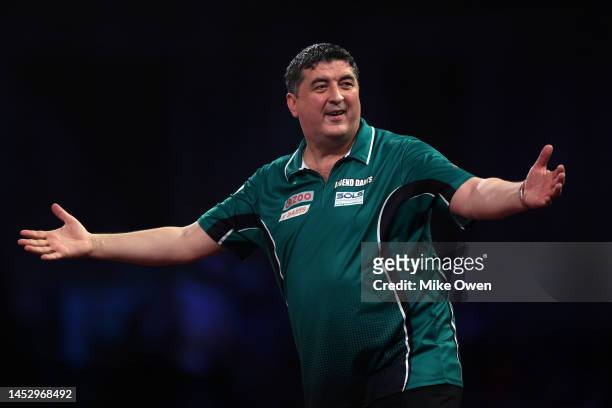 Mensur Suljovic of Serbia celebrates during his Third Round match against Michael van Gerwen of Netherlands during Day Nine of The Cazoo World Darts...