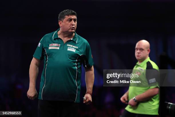 Mensur Suljovic of Serbia celebrates during his Third Round match against Michael van Gerwen of Netherlands during Day Nine of The Cazoo World Darts...