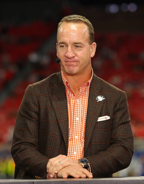 Former Football Quarterback Peyton Manning talks prior to the SEC Championship game between the LSU Tigers and the Georgia Bulldogs at Mercedes-Benz...