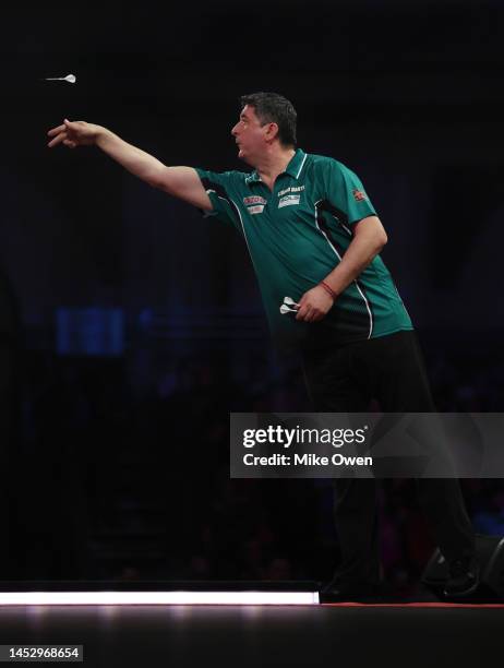 Mensur Suljovic of Serbia competes during his Third Round match against Michael van Gerwen of Netherlands during Day Nine of The Cazoo World Darts...