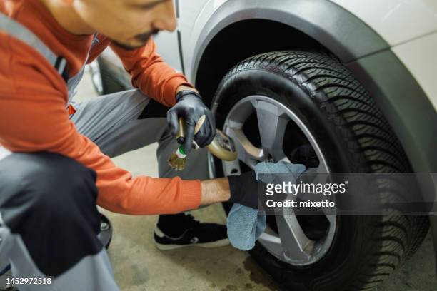 professional car detailer cleaning vehicle tire - microfiber towel stock pictures, royalty-free photos & images