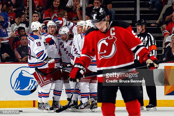 Ruslan Fedotenko of the New York Rangers celebrates with his teammates after scoring a goal in the second period as Zach Parise of the New Jersey...