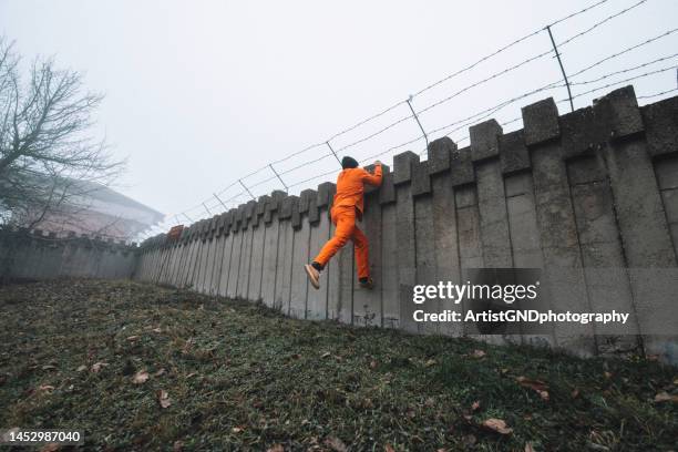 prisoner escaping from prison. - prison escape stock pictures, royalty-free photos & images