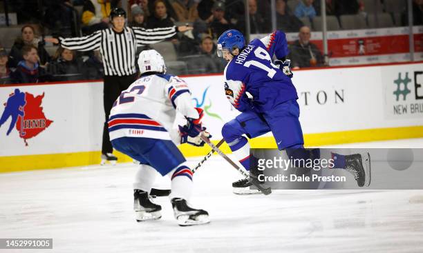Sean Behrens of Team USA defends as Samuel Honzek of Team Slovakia skates puck into the USA zone during the first period of their game during the...
