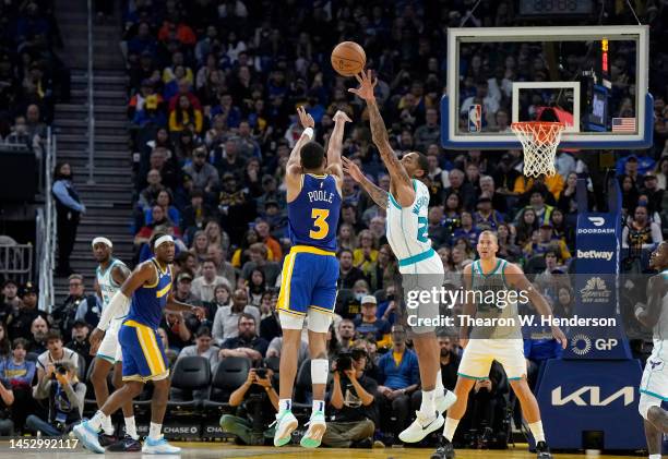 Jordan Poole of the Golden State Warriors shoots a three-point shot over P.J. Washington of the Charlotte Hornetsduring the second quarter of an NBA...