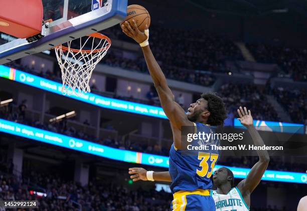 James Wiseman of the Golden State Warriors goes in for a layup over JT Thor of the Charlotte Hornets during the third quarter at Chase Center on...