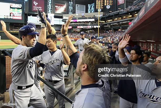 Ryan Braun of the Milwaukee Brewers high-fives Corey Hart in the dugout after Braun hit a two-run home run against the Arizona Diamondbacks during...