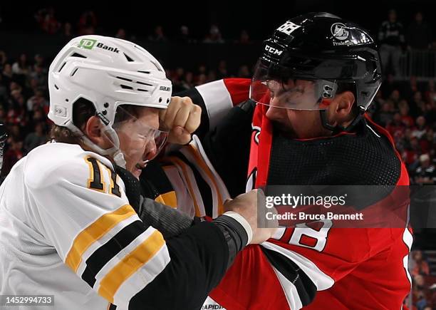 Trent Frederic of the Boston Bruins and Kevin Bahl of the New Jersey Devils fight during the first period at the Prudential Center on December 28,...