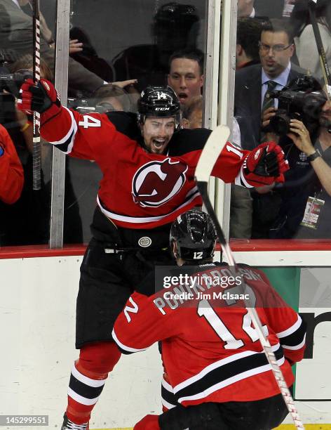 Adam Henrique of the New Jersey Devils celebrates with teammate Alexei Ponikarovsky after scoring in overtime against the New York Rangers to win...