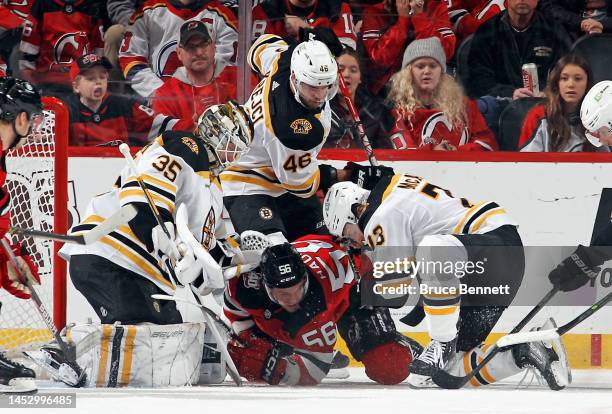 Linus Ullmark, David Krejci and Charlie McAvoy of the Boston Bruins defend against Erik Haula of the New Jersey Devils during the first period at the...